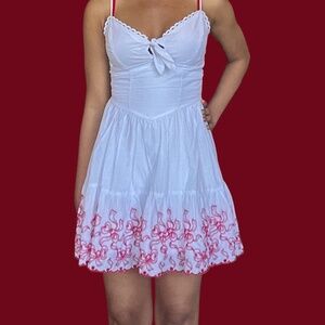 Mini dress with red bow detailing and a a peekaboo detail